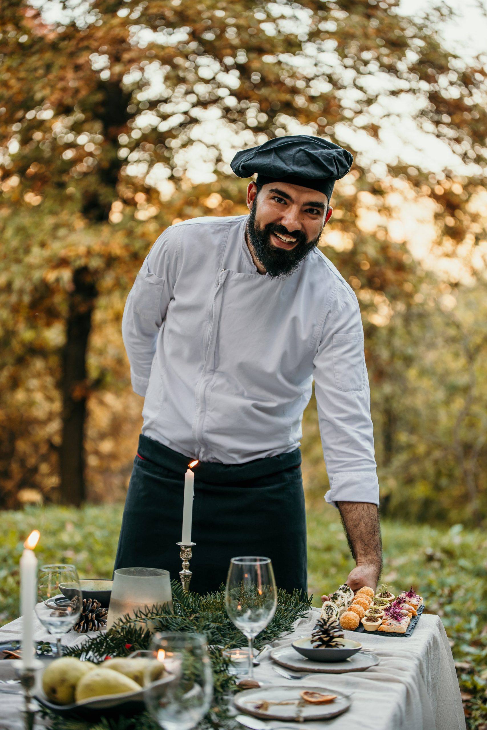 Chef presenting small plates at an outdoor catered event